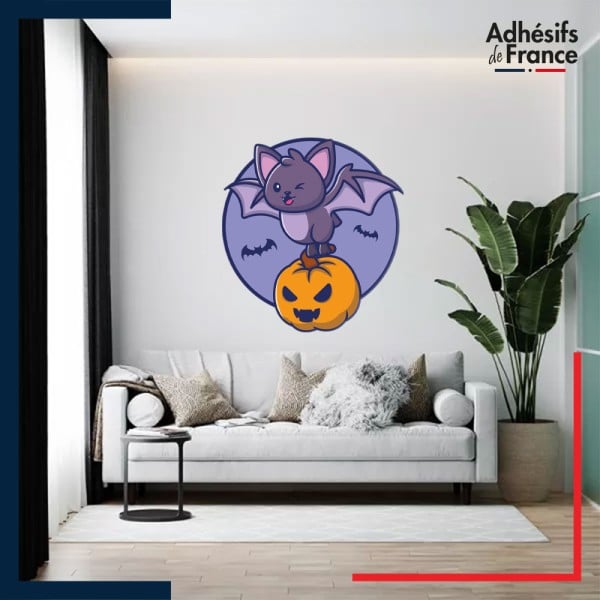 Autocollant ambiance Halloween Chauve-souris amusante portant une citrouille